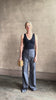 Mature woman reviewing Italian designer Tonne trouser from Callas rendered in a dark indigo and crafted from a viscose, polyester, and linen blend with beautiful fluid draping and effortless versitility similar to denim