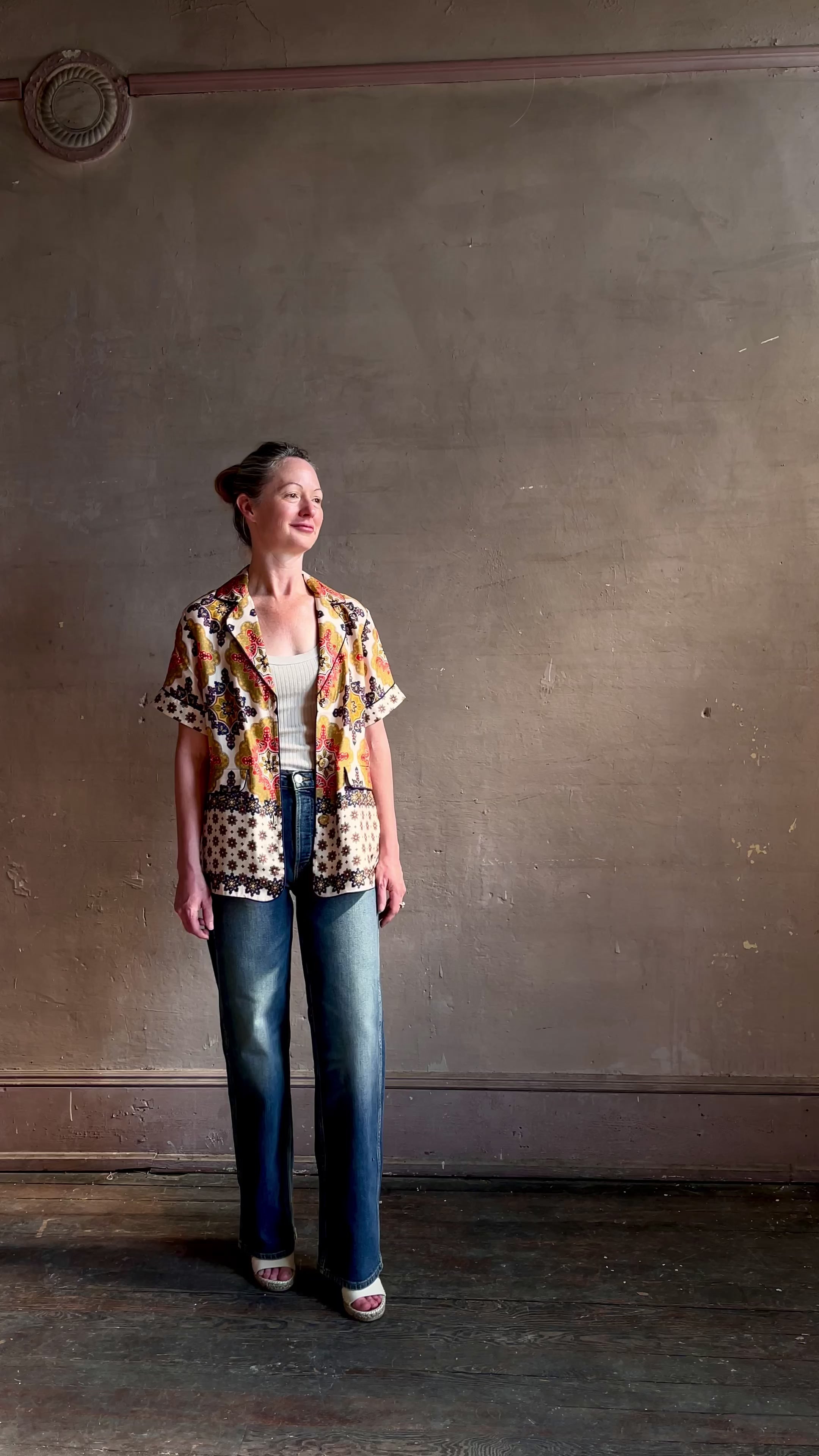 Video featuring a woman wearing the Portofino lightweight silk twill top from Cara Cara with a relaxed fit, contrast trim, pocket flaps and fusible collar in mandala Navy.