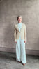 mature woman reviewing premium cashmere linen GUEST IN RESIDENCE Breezy Cardigan in Sandstone beige with long sleeves hook and eye front closure and ribbed texture