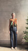 Mature woman reviewing Women's designer Gracie sleeveless Cotton Top from Ulla Johnson rendered in a rich abstract Agate print composed of dark green, mint green, burgundy, terra cotta, and sienna and crafted from lightweight cotton poplin