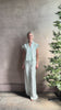 Mature woman reviewing Dorada short sleeve Shirt from Trovata rendered in a fresh aqua and cream Stripe and crafted from  cotton poplin with v-neck, collar and consealed button front