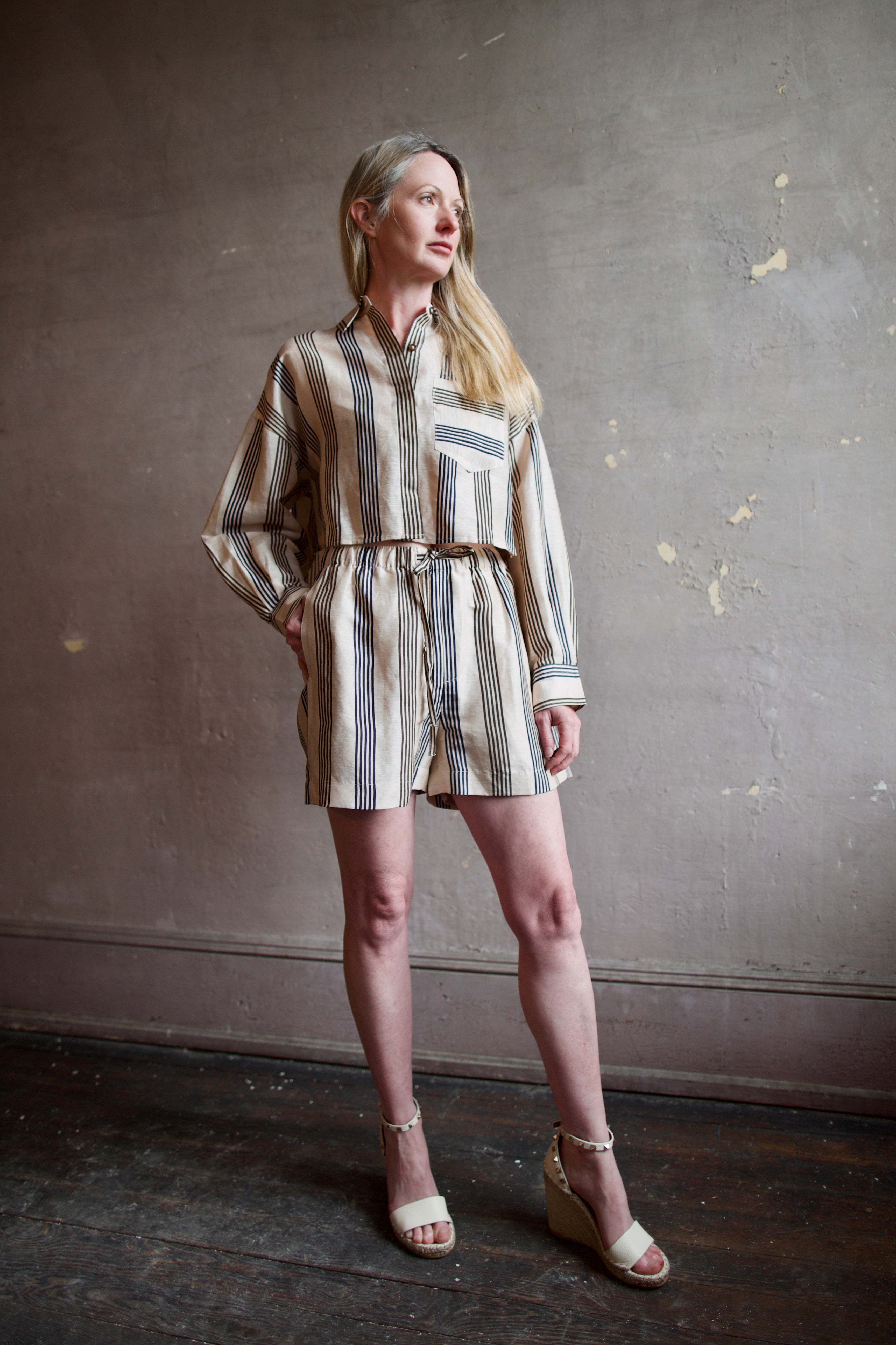 Mature model wearing the Rag and Bone Beatrice Top and Logan Beach Shorts in luxurious lightweight linen and silk fabric