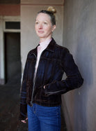 Image of woman wearing the Re/Done slim jacket and the Forte Forte silk satin crater neck top