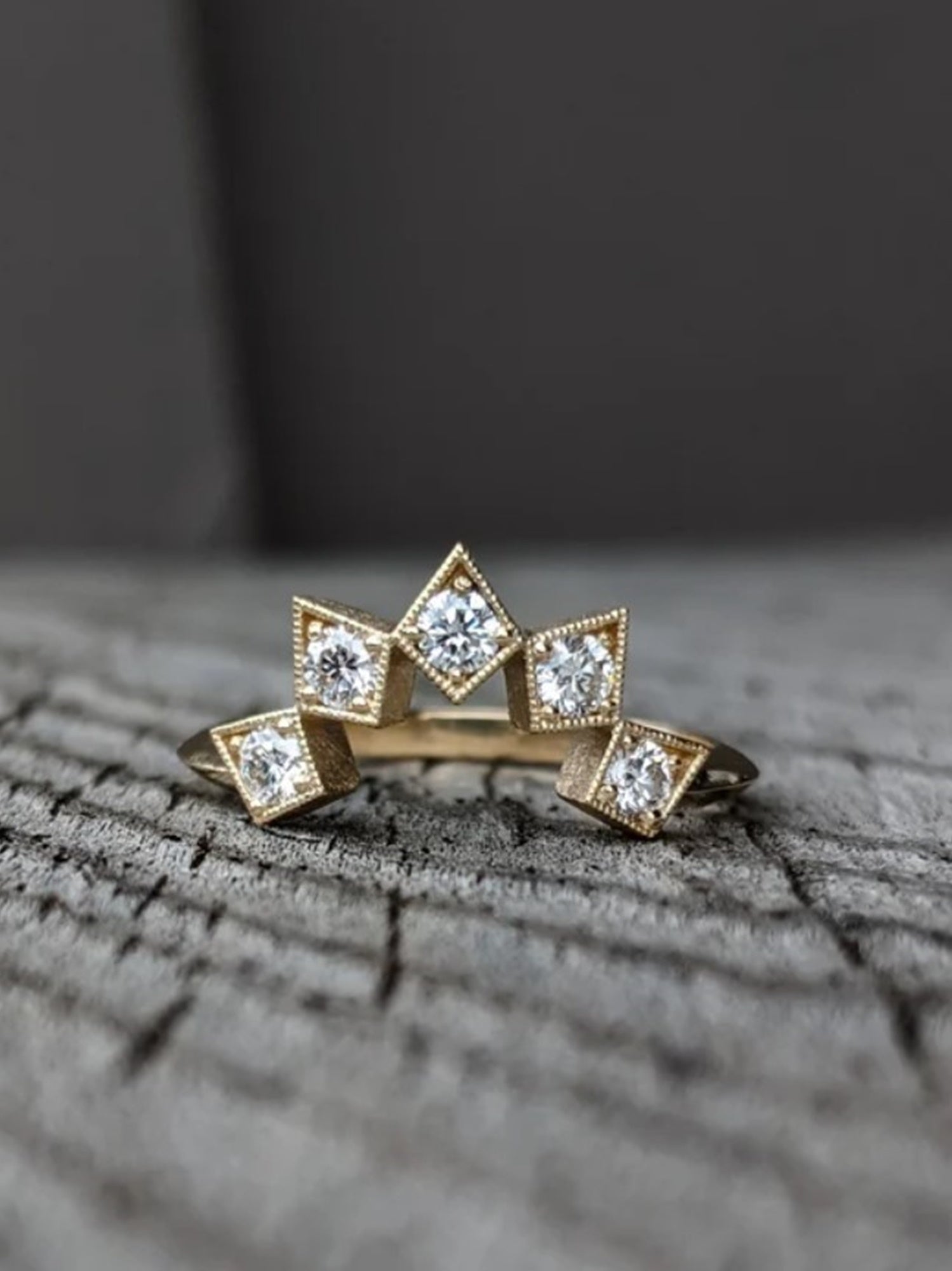 Image of North Carolina artist Stephanie Ellis 14k yellow gold band ring with six premium round brilliant natural diamonds set in it a star-inspired configuration