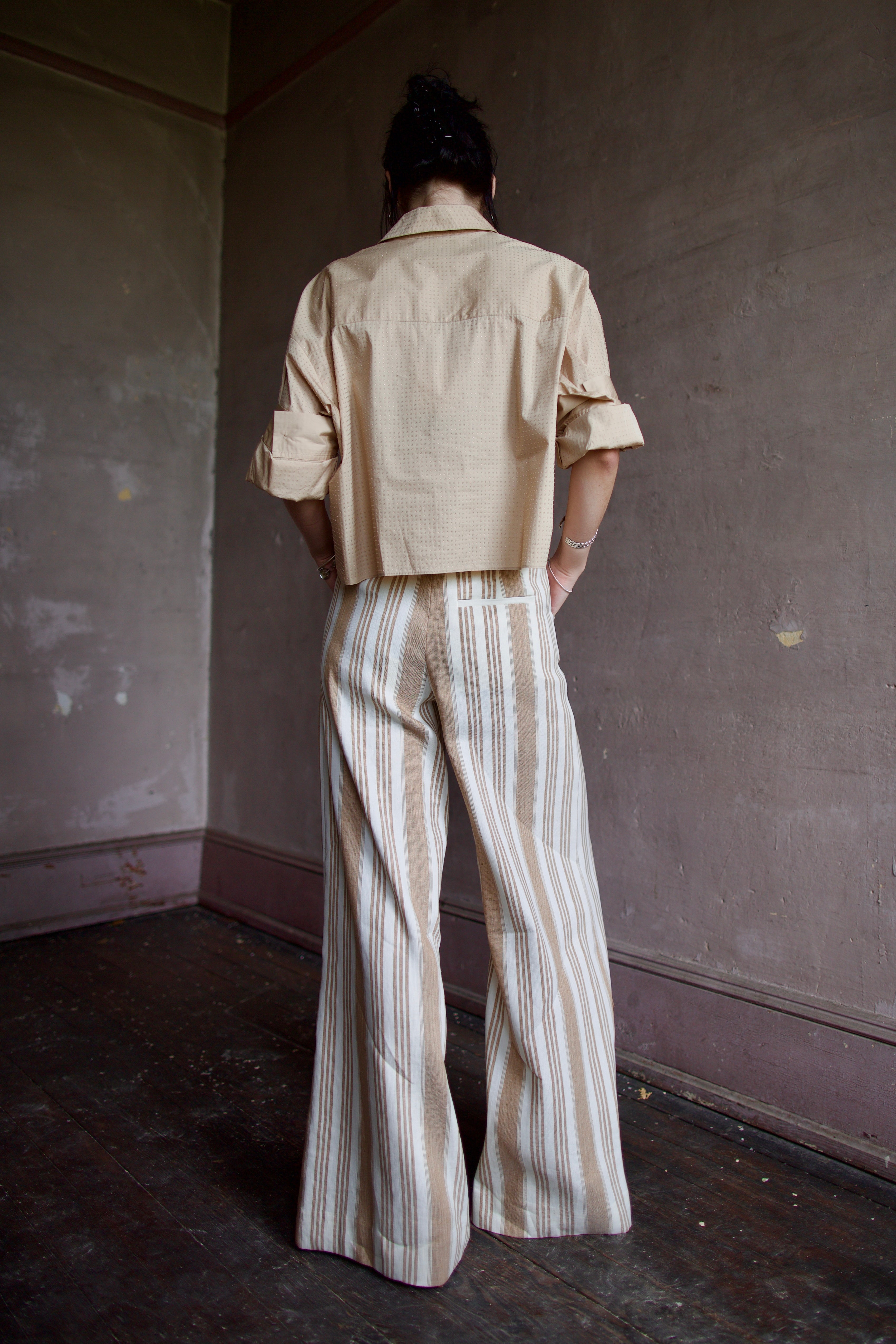 Back image of a woman wearing the TWP Next Ex with Crystals and the Demie Trousers without Pintucks