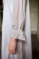 Detail image of a woman wearing the TWP Jenny's Gown in Brown Stripe