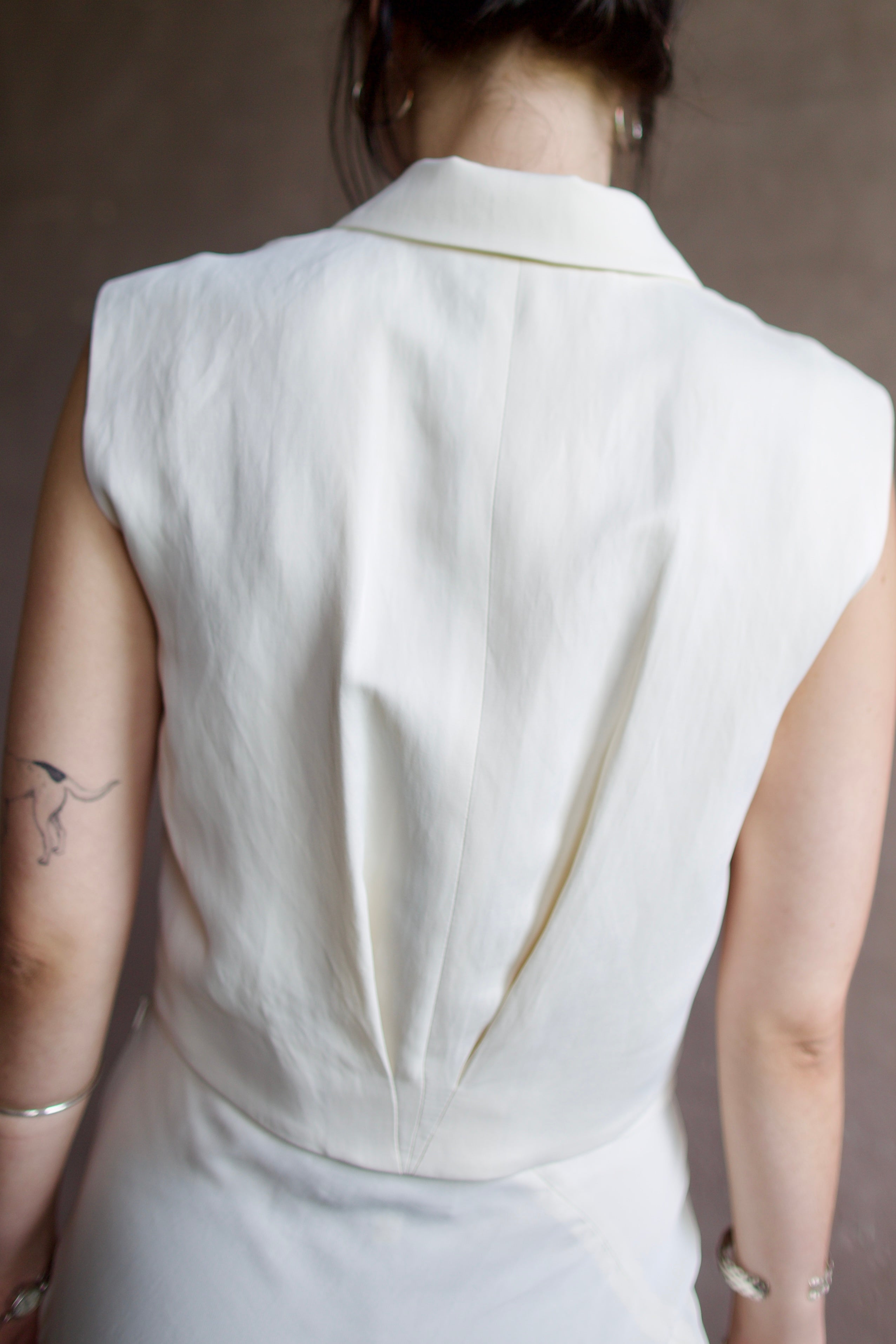 Back detail of a woman wearing the TWP Katie Cropped Tailored Vest
