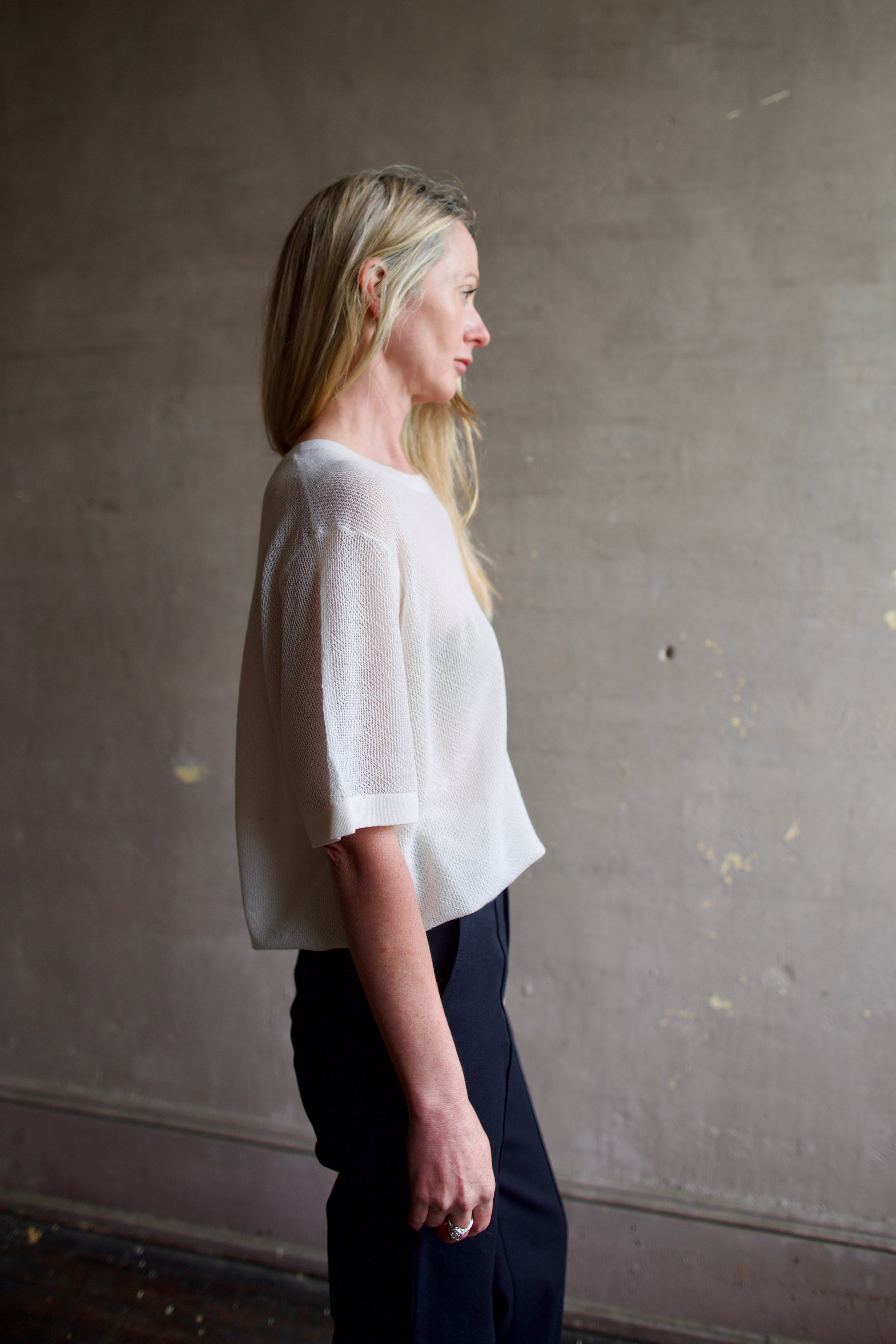 Side view Image of a woman wearing the TWP Knit Tee with Pointelle in Ivory