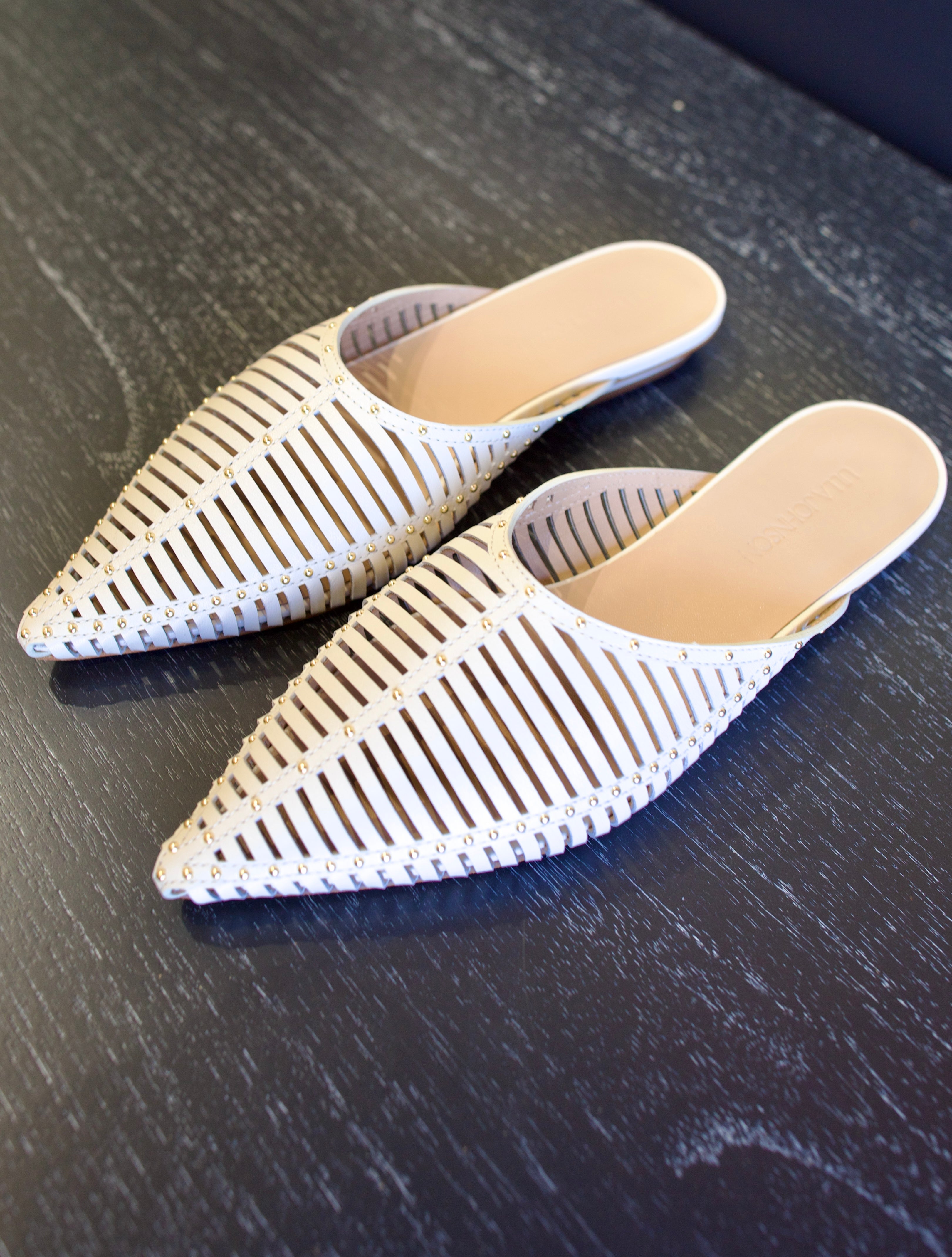 Image of white Ulla Johnson Octavia Mule shoe with gold studs slip on premium leather shoe with pointed toe