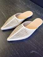 Ulla Johnson Octavia Mule in Alabaster premium leather with caged construction and gold stud detailing. Architectural, effortless warm-weather elegance.