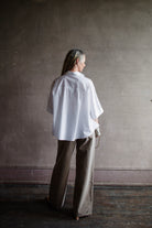 Image featuring a woman wearing he Bobby shirt by Vanessa Bruno features a button front and oversized, boxy fit.