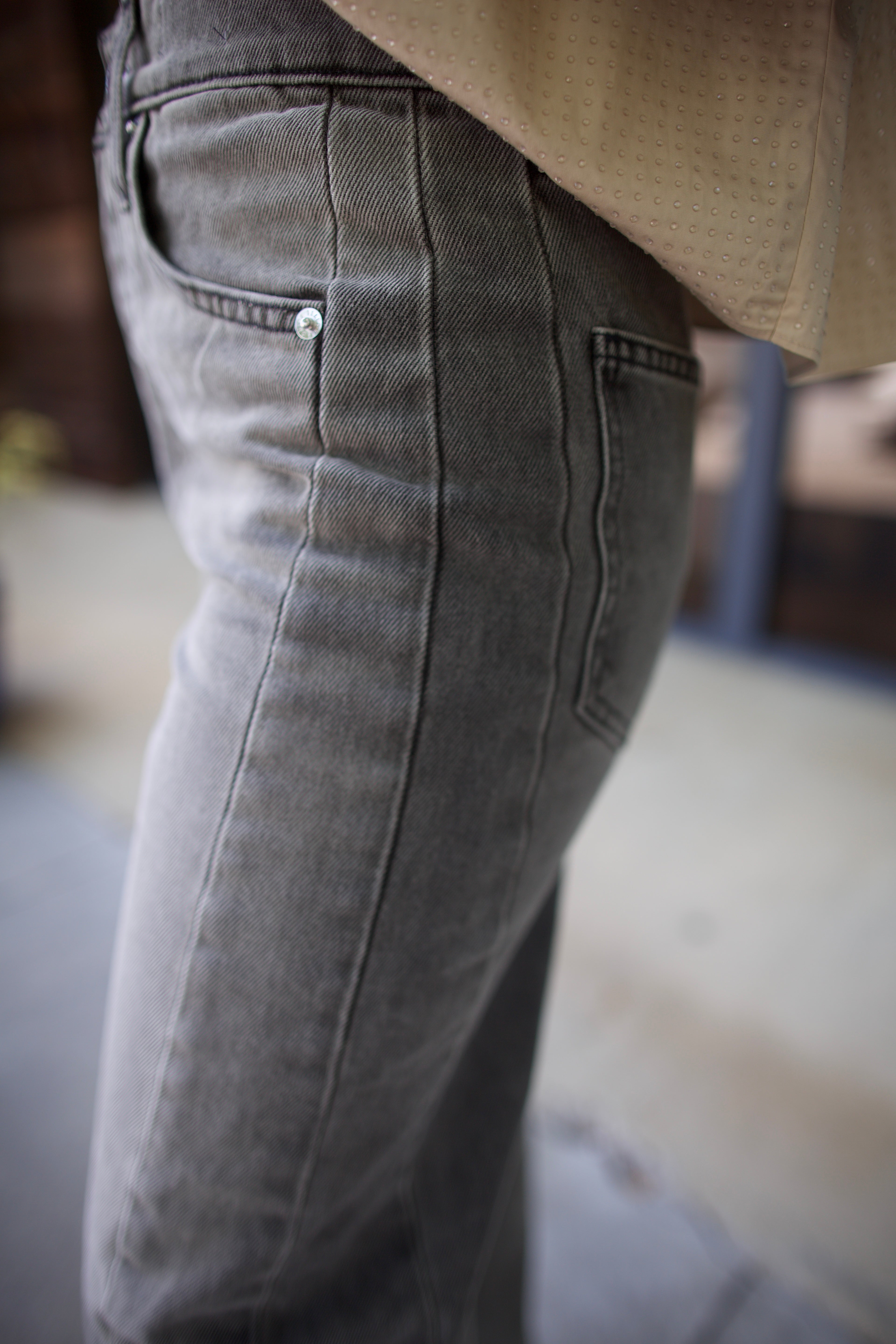 Mature model wearing designer brand Veronica Beard high rise Ryder grey barrel denim fabricated with rigid cotton 