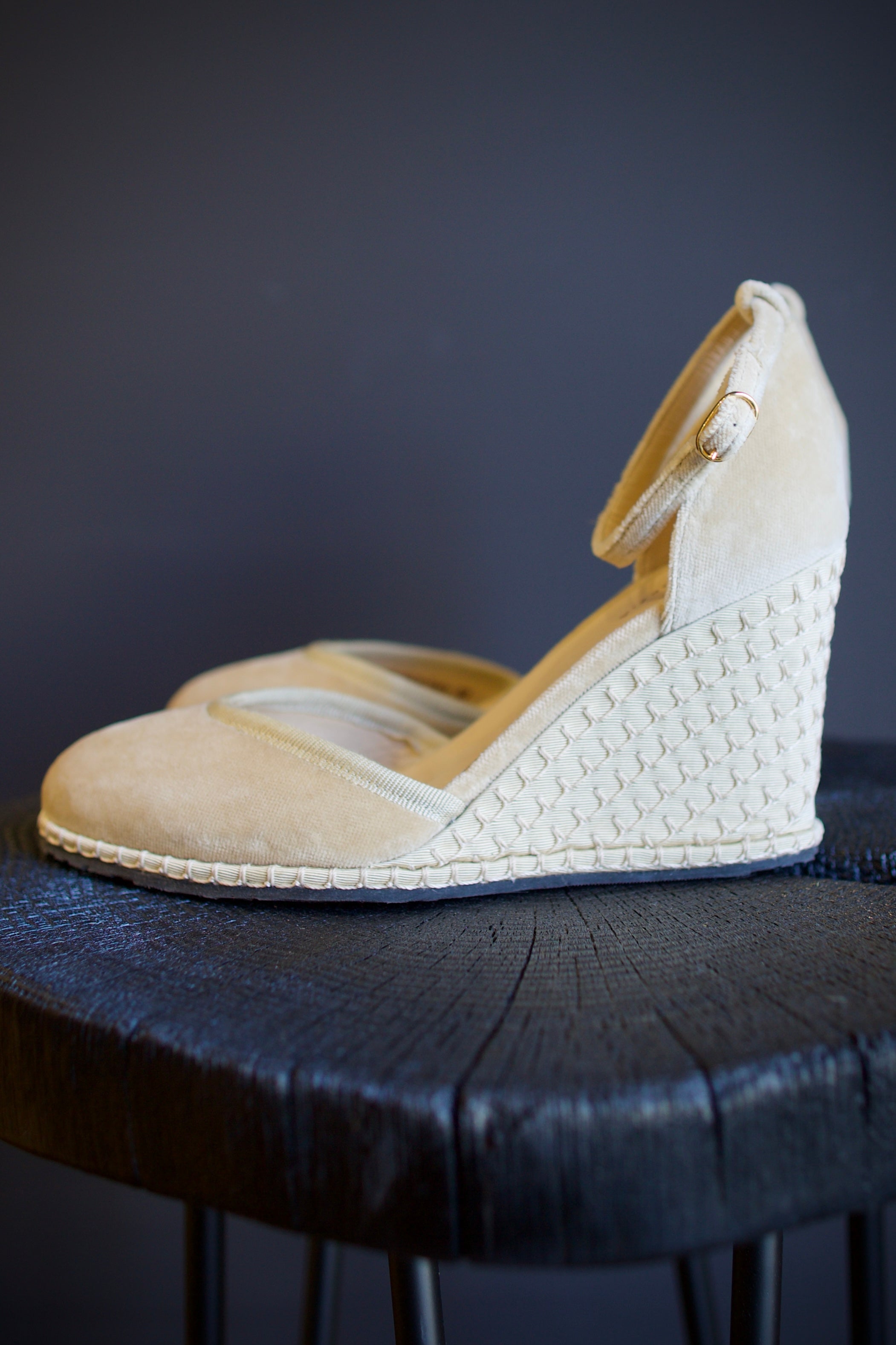 A pair of beige Vibi espadrille wedge heels in beautiful neutral velvet with  round toe, ankle straps and buckle closures.