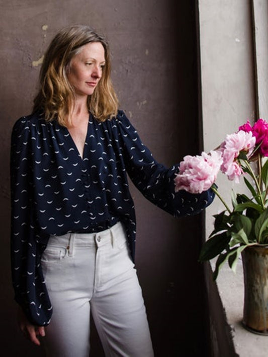 Image featuring a woman wearing the Turin Polka Wings navy blue blouse by Zadig & Voltaire crafted in silk with exaggerated sleeves and a button front.